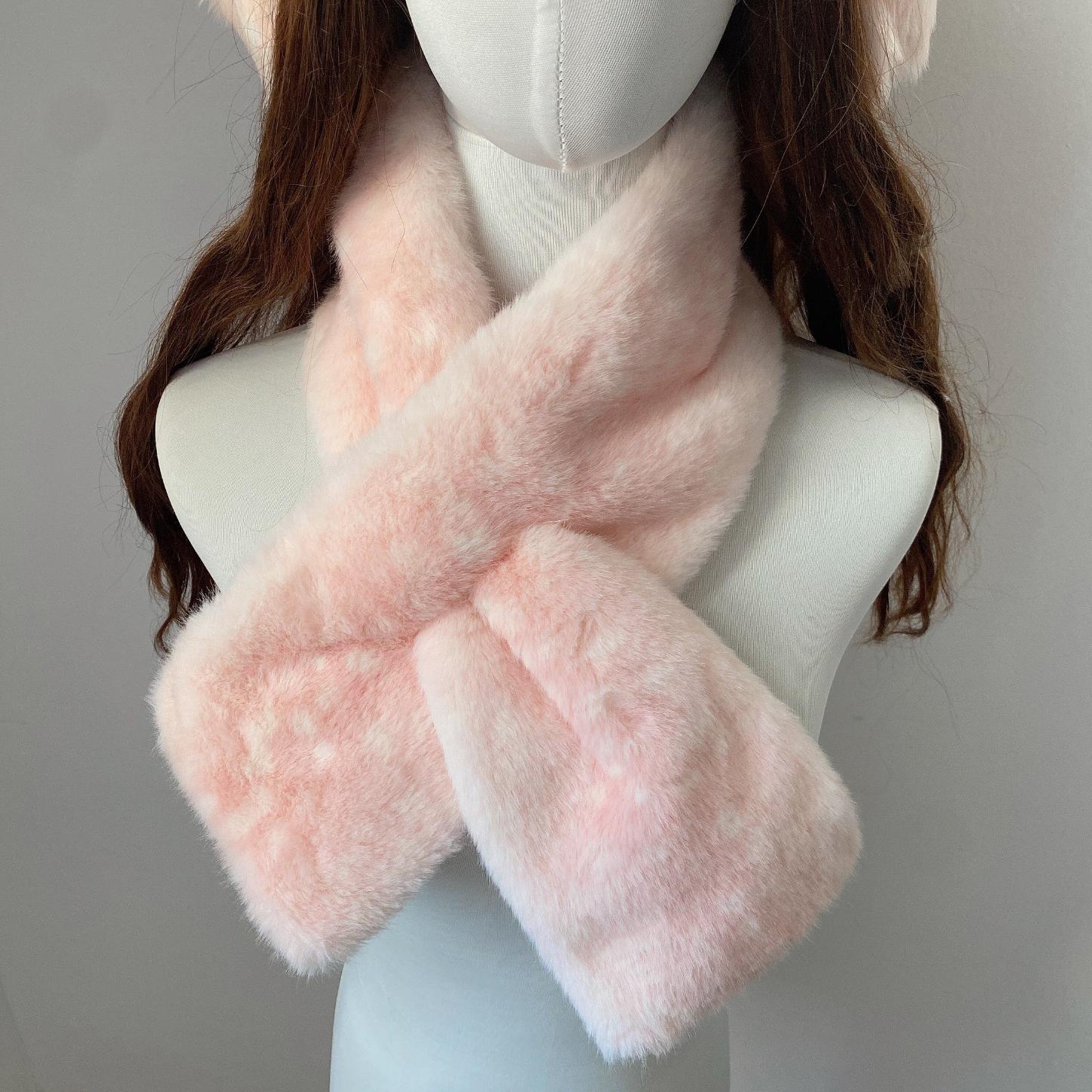 Mannequin wearing a pink fluffy deer pattern scarf against a neutral background
