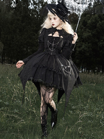 Person in a black gothic dress standing in a grassy field