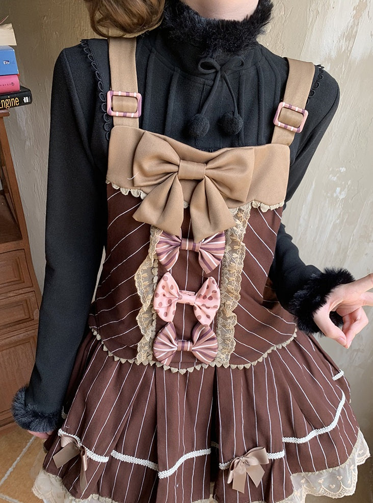 Person wearing a brown pinstripe dress with decorative bows and straps.