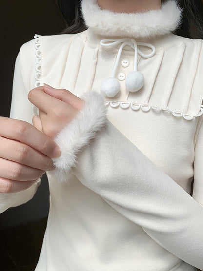 Close-up of a person wearing a white outfit with fur details.