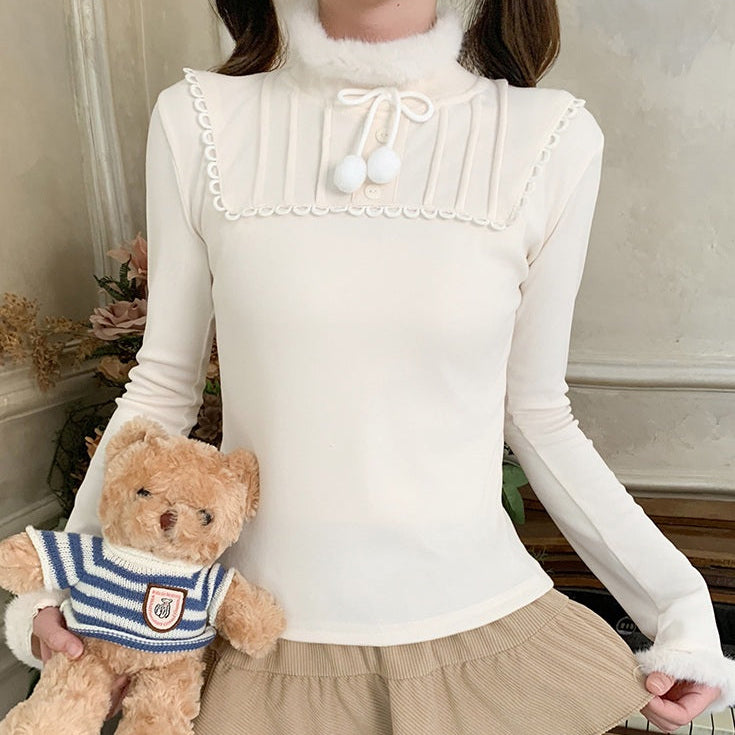 Person wearing a white long-sleeve top and beige skirt holding a teddy bear.