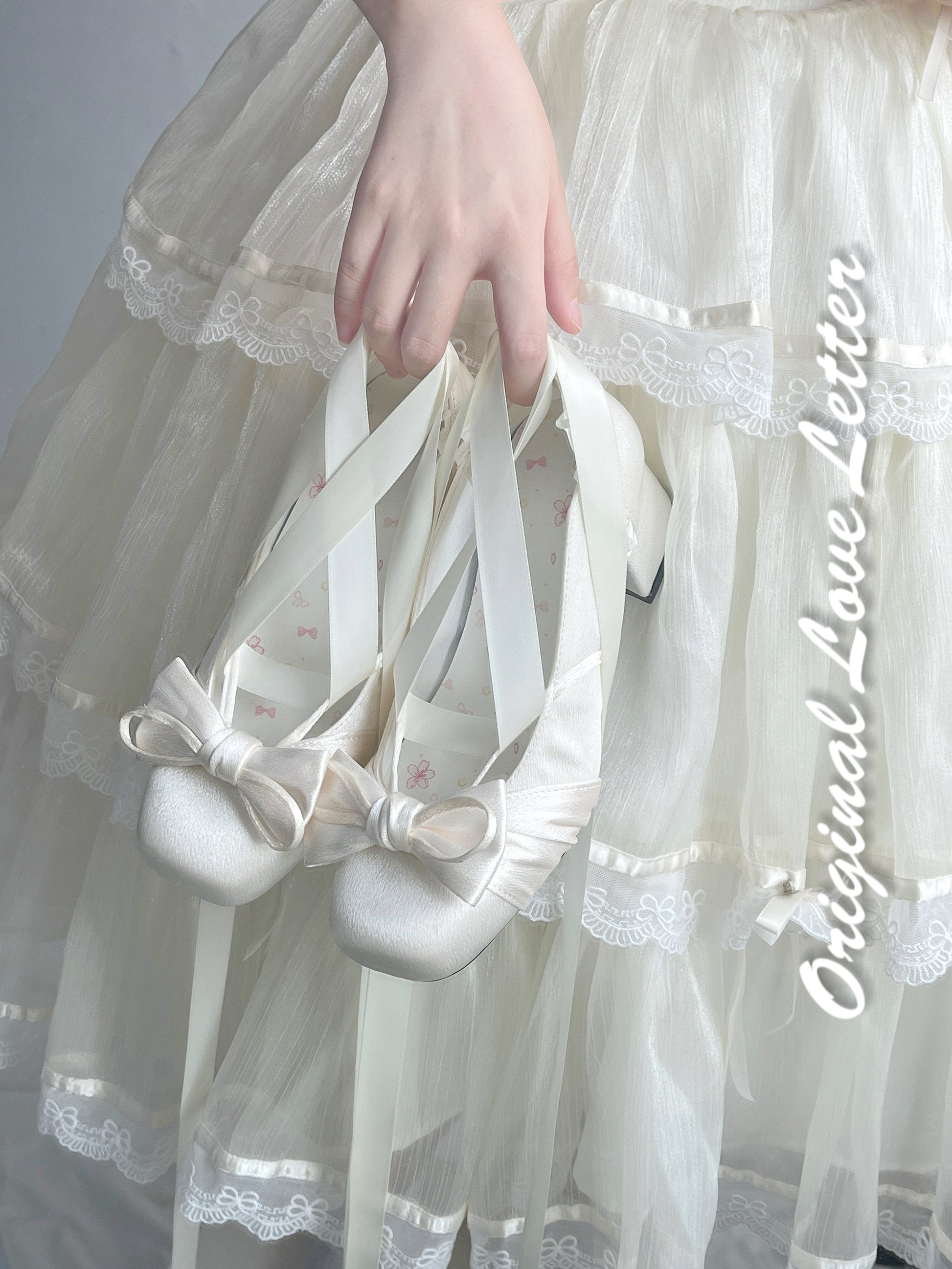 A collection of satin ballet shoes with ribbon wristbands, available in multiple colors including blue, pink, white, black, red, and silver.