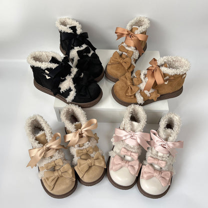 Set of lolita style winter boots with bows on a white background