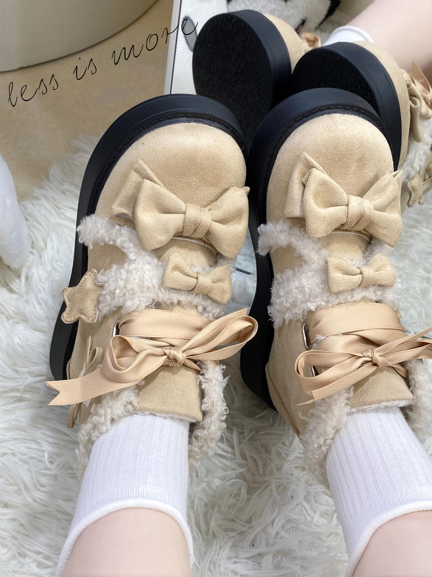 Beige lolita style boots with bows on a fluffy white surface