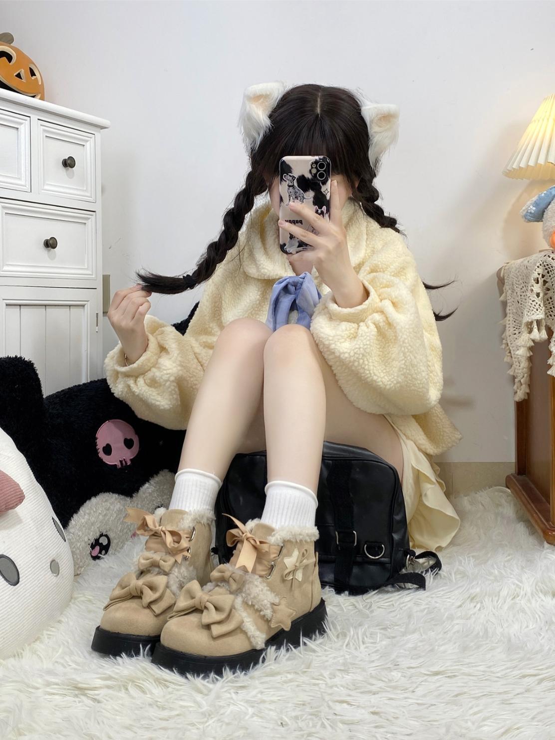 Person wearing a yellow sweater and beige boots with bows, sitting on a white rug.