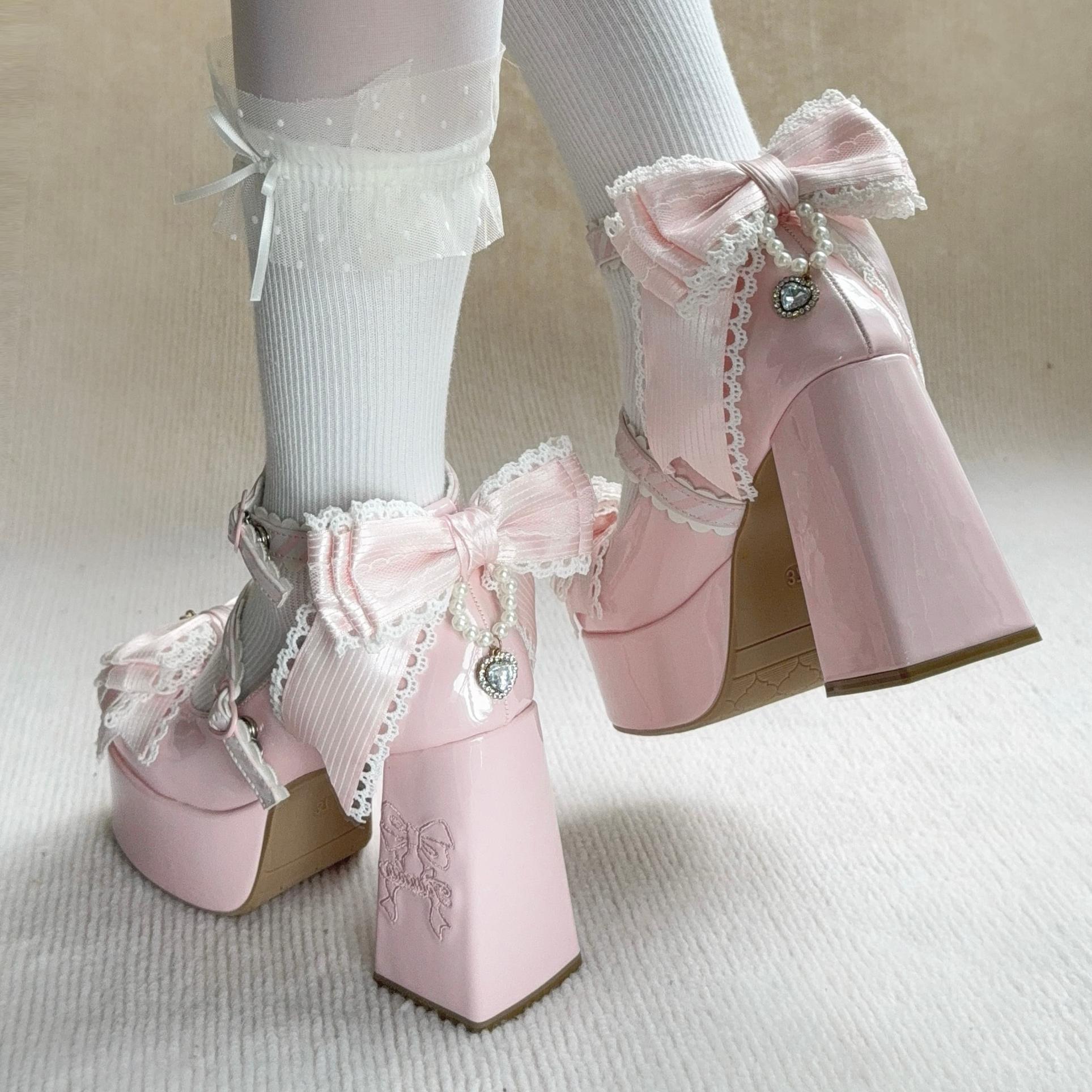 Pink platform boots with lace details on a neutral background