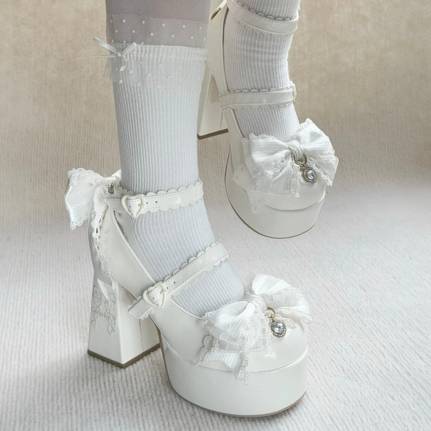 White platform shoes with decorative bows and ribbons on a neutral background