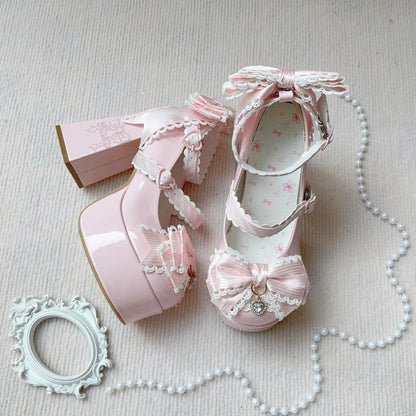 Pink women shoes with decorative bows and ribbons on a light background
