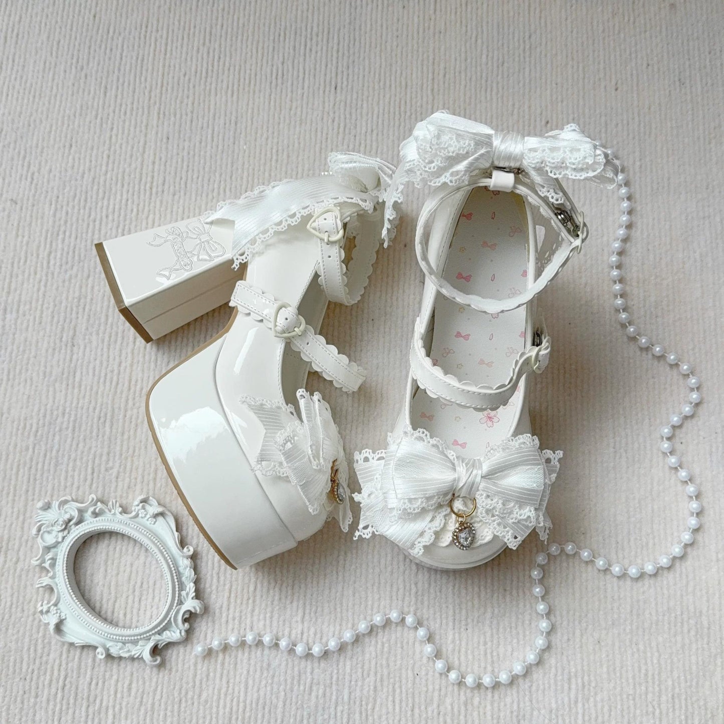 White lace-up shoes with decorative elements on a light background