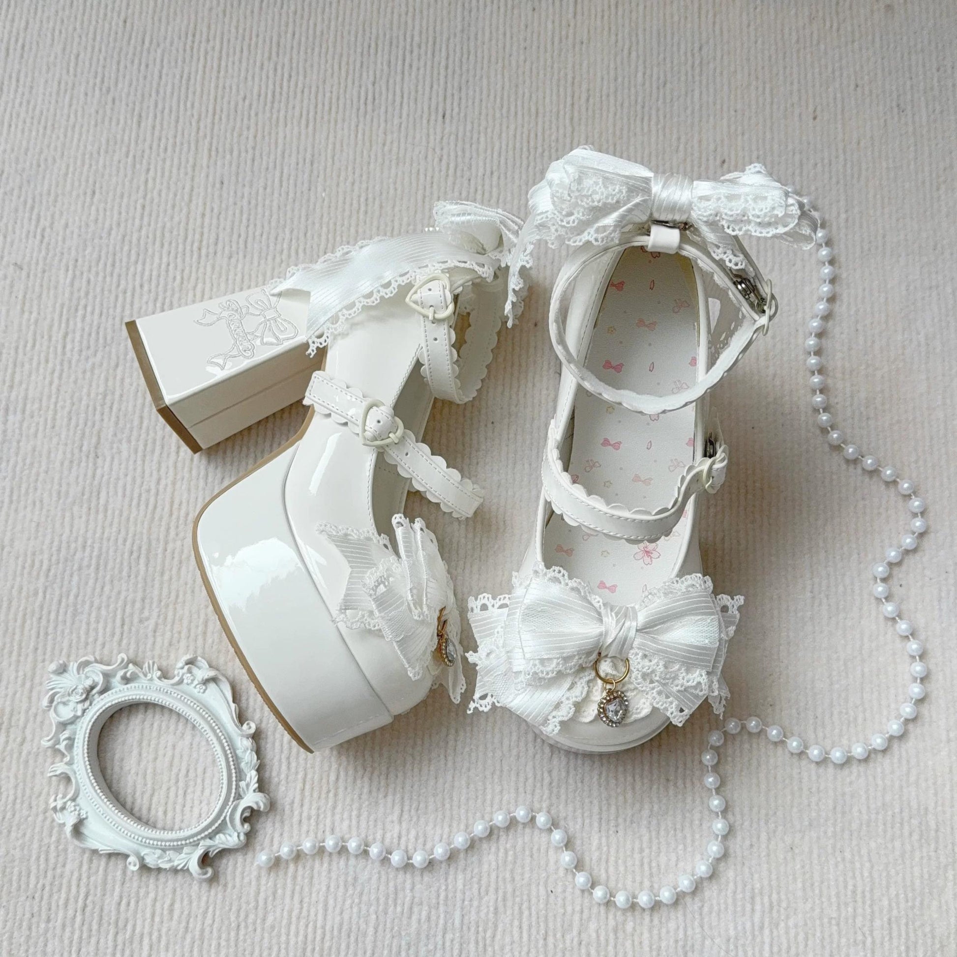 White lace-up shoes with decorative elements on a light background