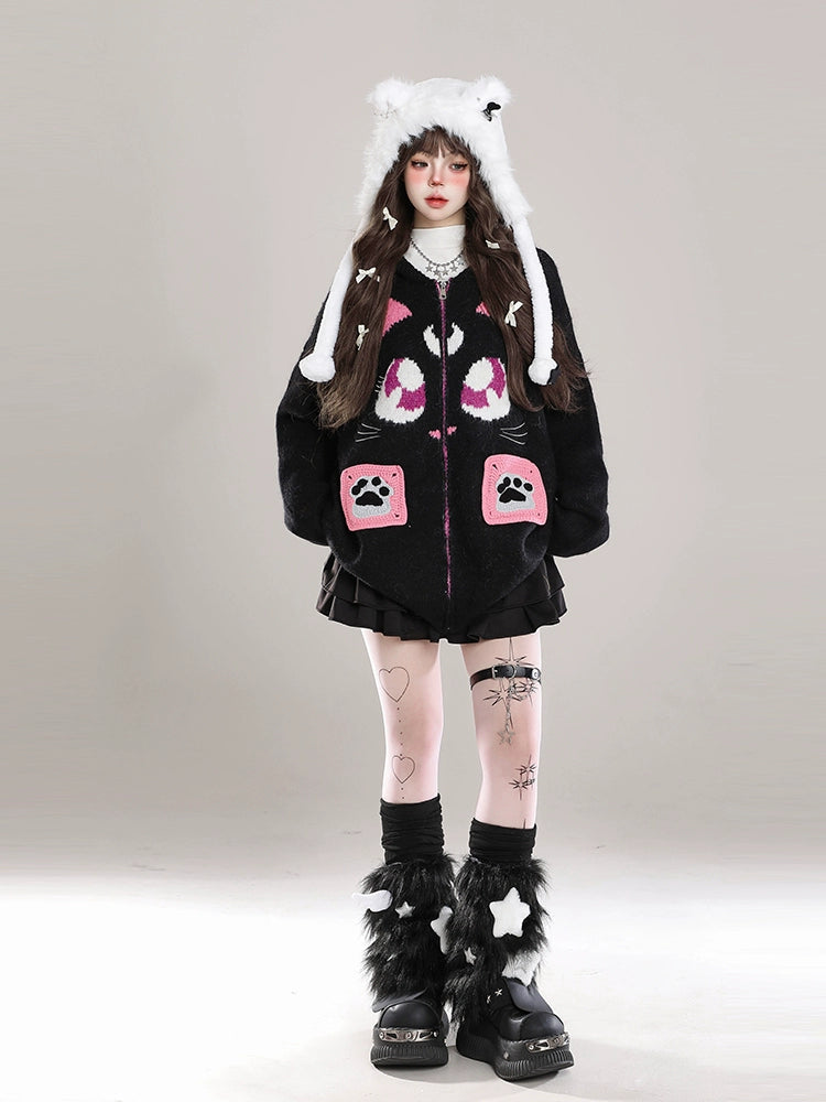 Person wearing a black outfit with pink paw prints and white hat on a gray background