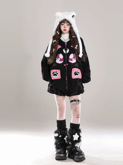 Person wearing a black outfit with pink paw prints and white hat on a gray background