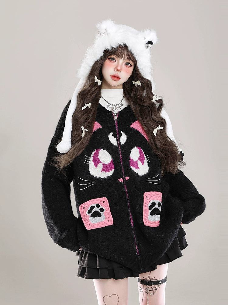 Person wearing a black hoodie with pink paw prints and white fur trim on a plain background