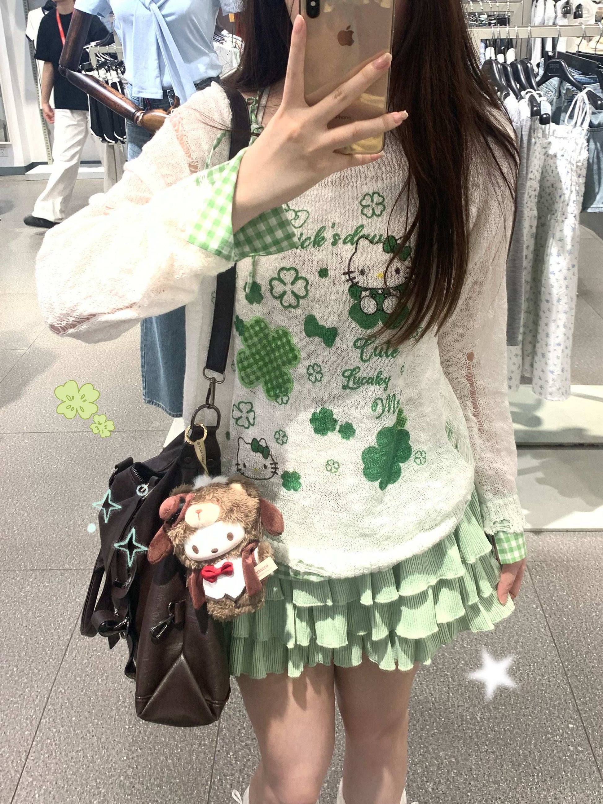 Person wearing a green and white outfit with shamrock patterns, holding a brown bag with a plush toy.