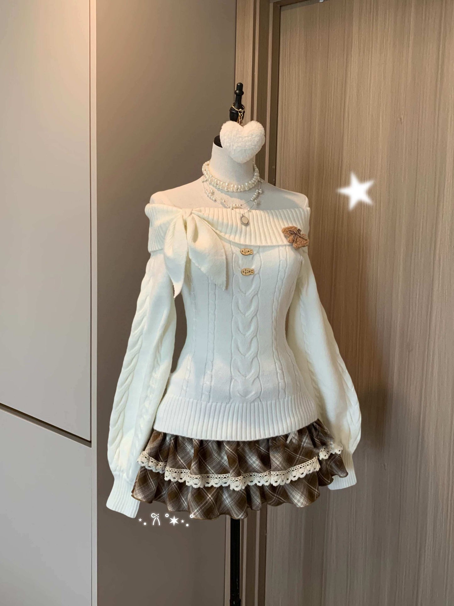 Mannequin wearing a white sweater and brown checkered skirt against a neutral background
