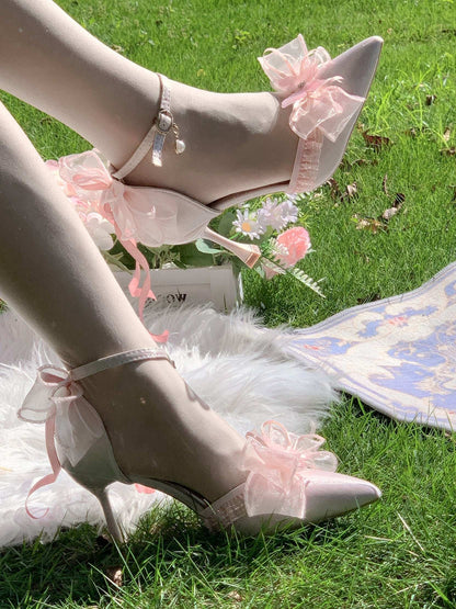 High-heeled shoes with floral decorations on a grassy background