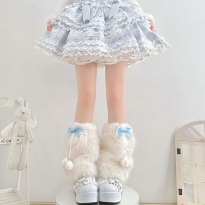 Person wearing a white dress with blue patterns, white knee-high socks with bows, and white shoes in a room.