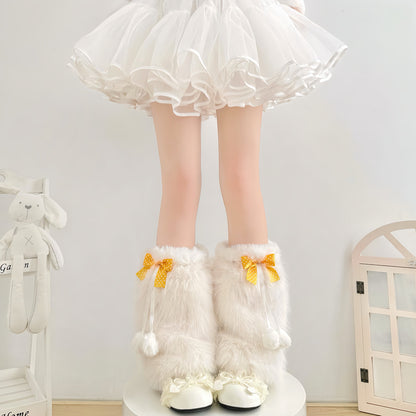 White fluffy knee-high boots with yellow bows worn by a person in a white skirt.