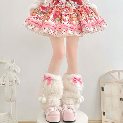 Person wearing a colorful dress with a strawberry pattern and white fluffy boots with pink bows.