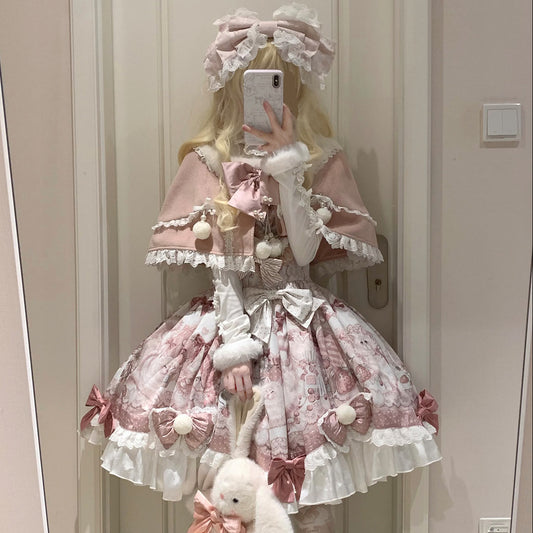 Person wearing a pink and white Lolita-style outfit with a bear plushie, standing in front of a mirror.