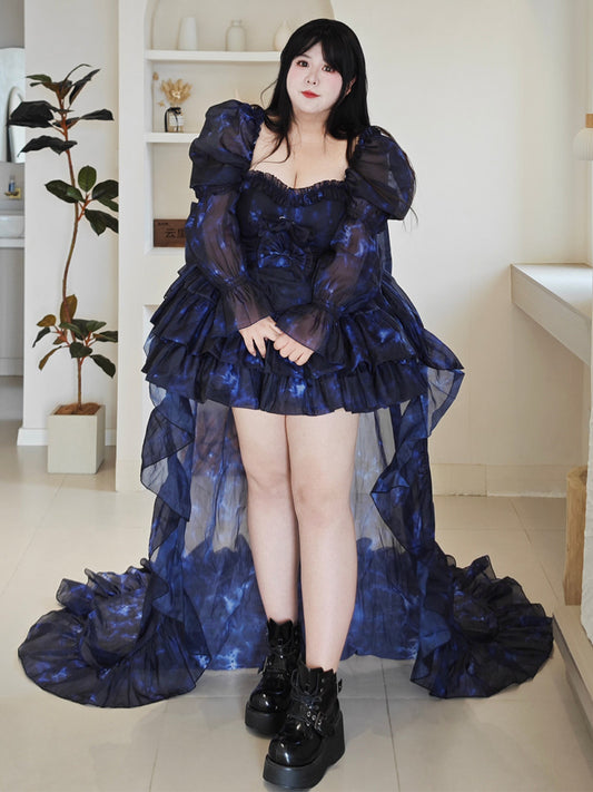 Plus Size Woman wearing a dark blue, ruffled dress with a high-low hem in an indoor setting.