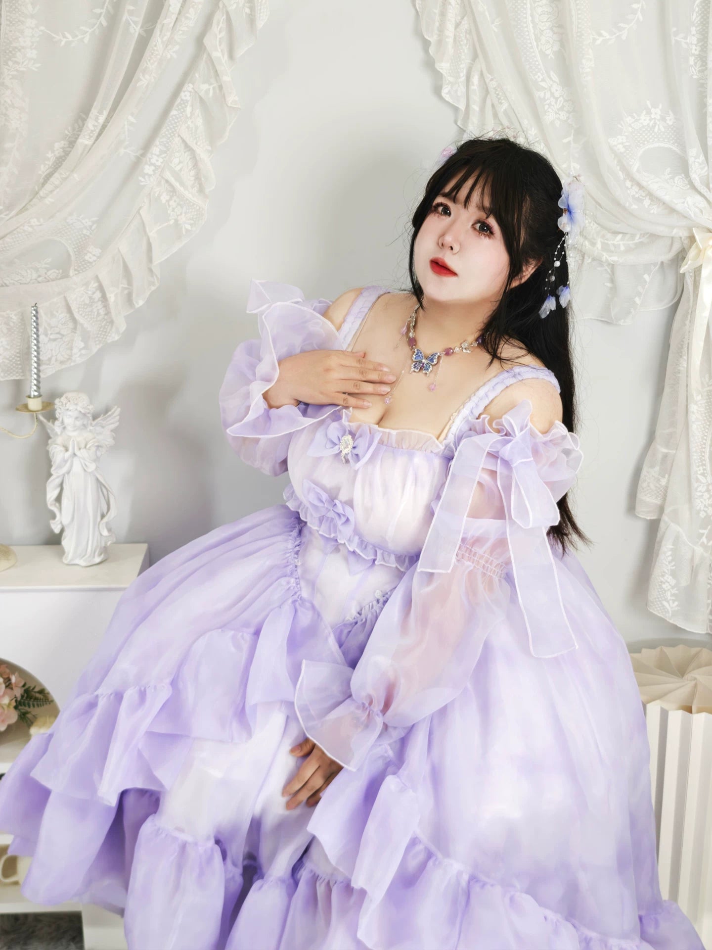 Woman in a lavender dress with floral decorations in an elegant room.