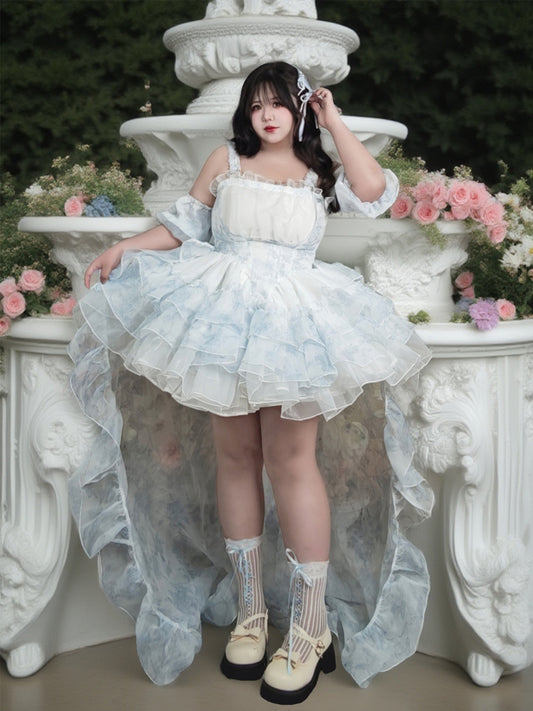 Woman in a white dress standing in front of a decorative fountain with flowers.