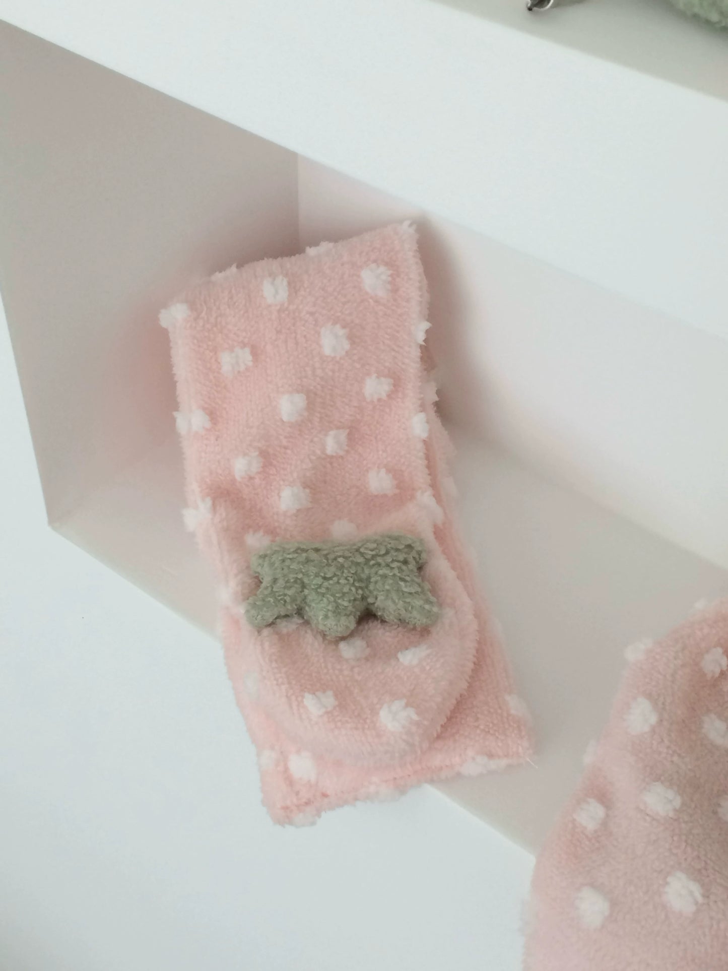 Pink polka dot strawberry scarf with a green star design on a white background