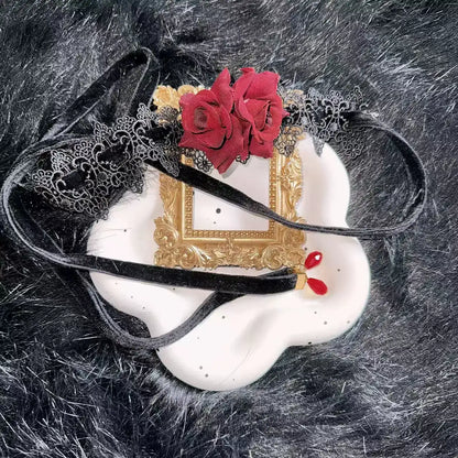 Decorative choker with red flowers and gold frame on a textured black background