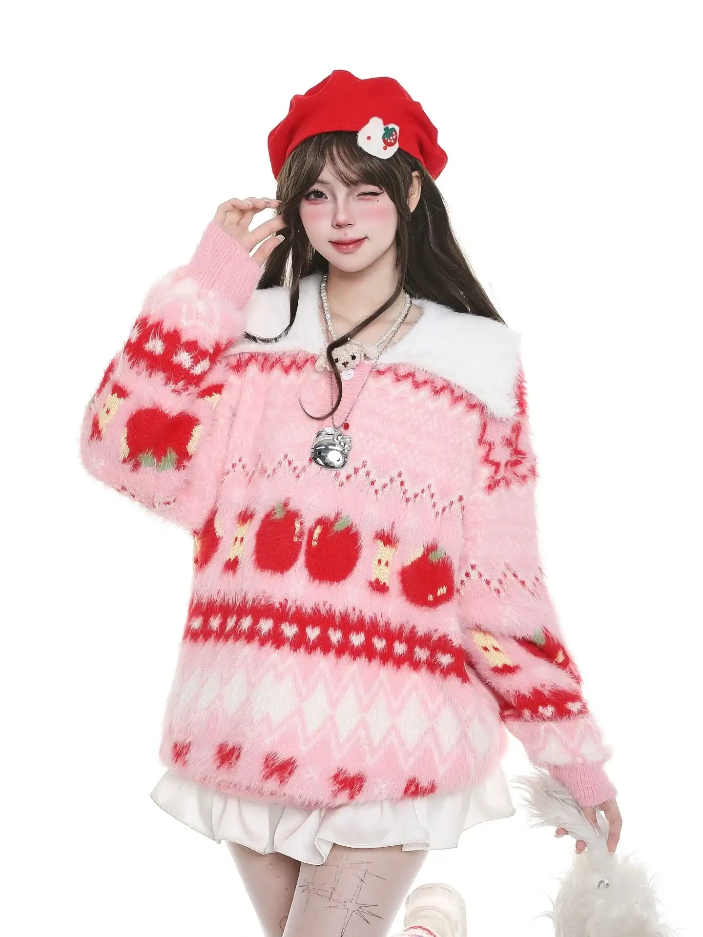 Person wearing a pink sweater with red patterns and a red beret on a white background