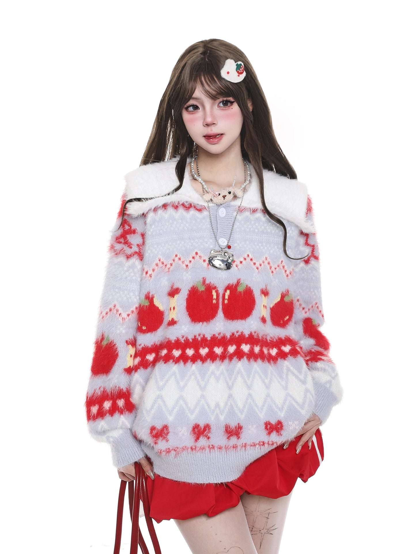 Person wearing a festive sweater with red and white patterns on a white background