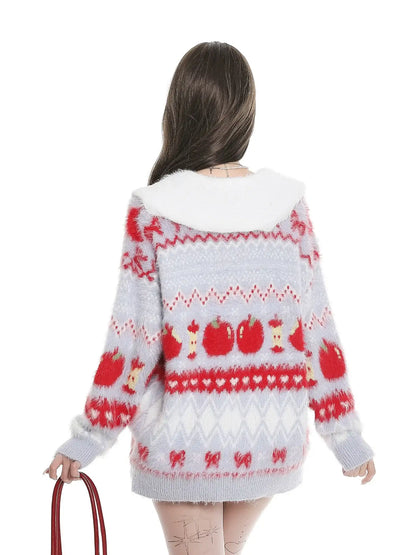 Person wearing a patterned sweater with red and white design on a white background