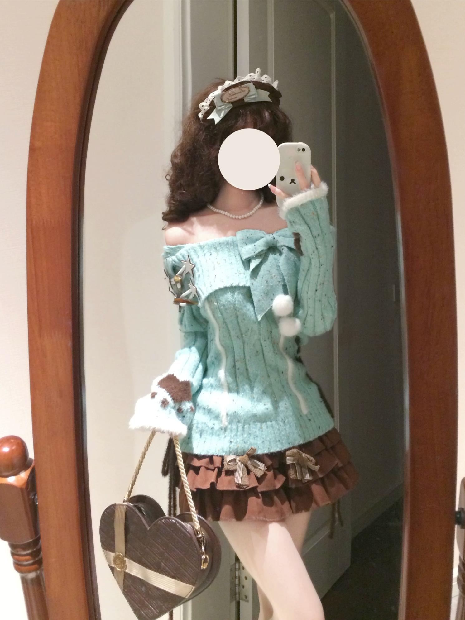 Person wearing a light blue sweater with white fur trim and a brown skirt, standing in front of a mirror.