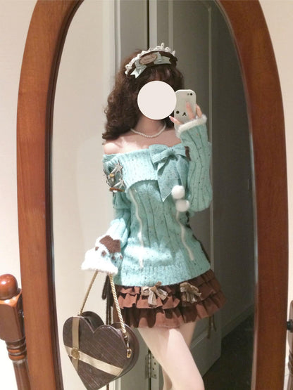 Person wearing a light blue sweater with white fur trim and a brown skirt, standing in front of a mirror.