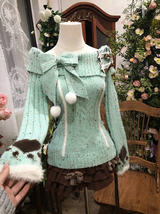 Light blue knitted dress with decorative elements on a mannequin against a floral and wooden chair background.