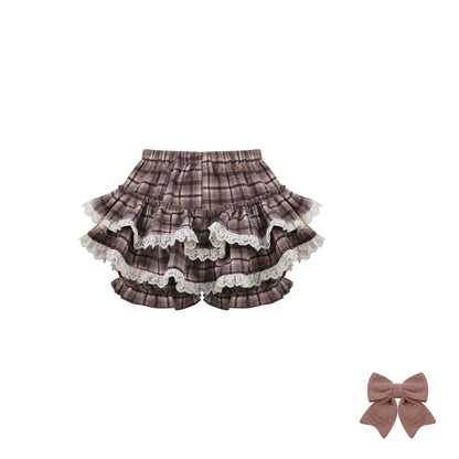 Plaid ruffled shorts with lace trim and a matching bow on a white background