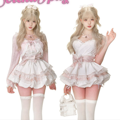 Two women in matching white outfits with pink accents, standing on a pink surface.