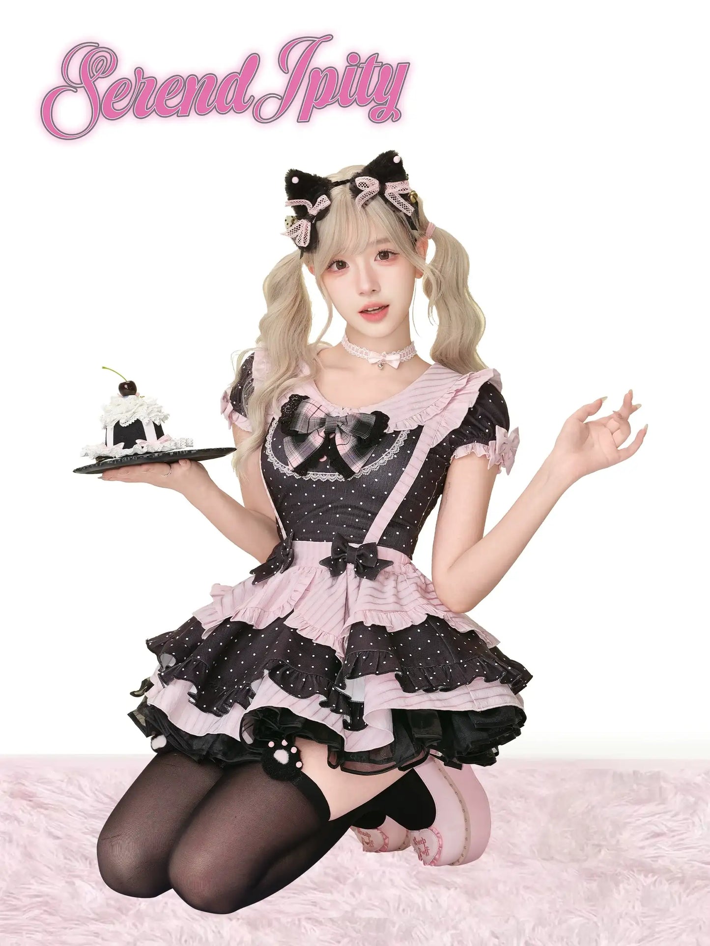black top with polka dots, pink edges, and bows, paired with suspender skirt
