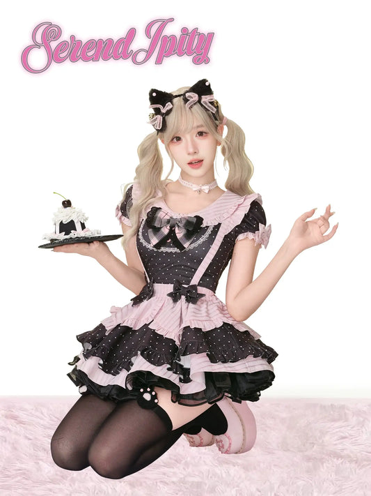 black top with polka dots, pink edges, and bows, paired with suspender skirt
