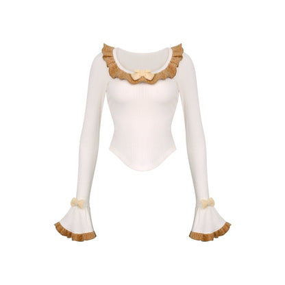 White long-sleeve top with brown trim on a white background