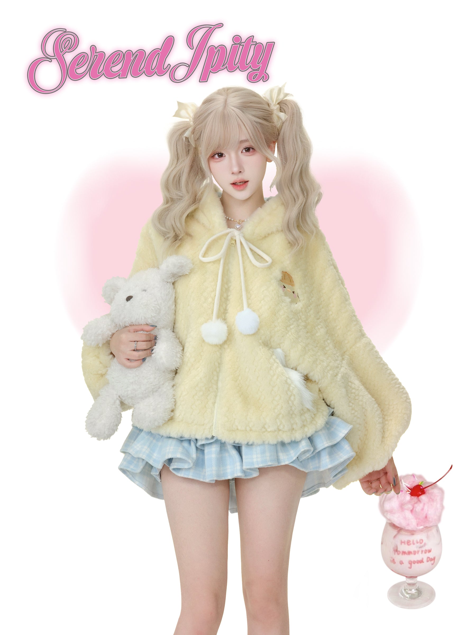 Person wearing a fluffy yellow coat with a pink background and 'Serendipity' text.