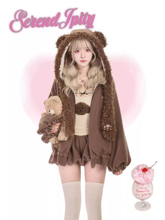 Person wearing a brown teddy bear-themed outfit with a 'Serendipity' logo.