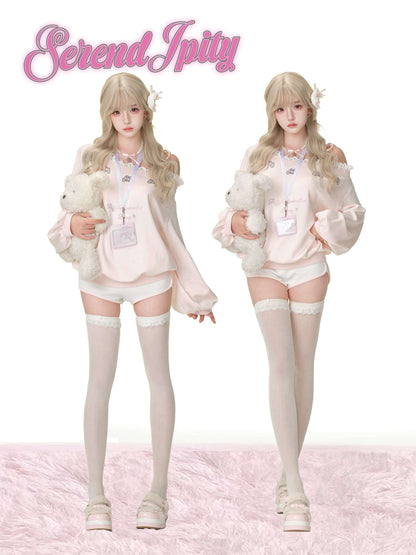 Two people in matching outfits with teddy bears on a pink background