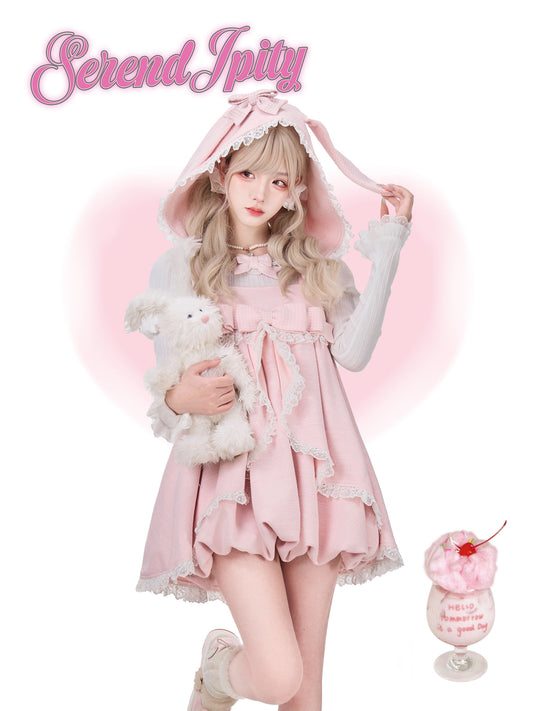 Person wearing a pink dress with a hood, holding a white plush toy, on a white background