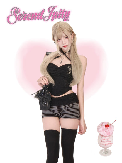 Person in black outfit with 'Serendipity' branding on a pink heart background