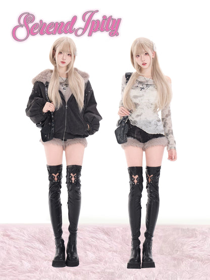 Two people wearing matching outfits with black knee-high boots on a white background