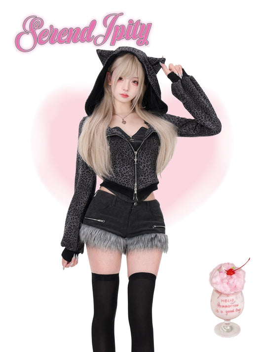 Person wearing a black cat-themed outfit with a pink background