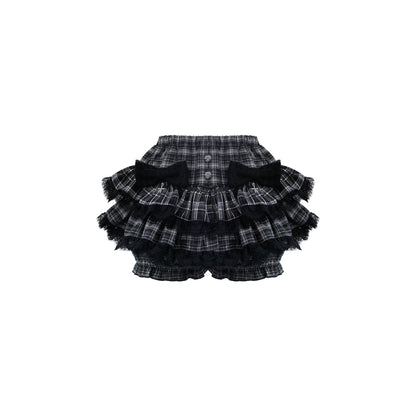 Plaid black skirt with ruffles on a white background