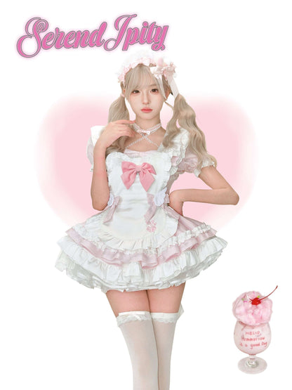 Person wearing a white lace dress with pink accents, standing against a white background