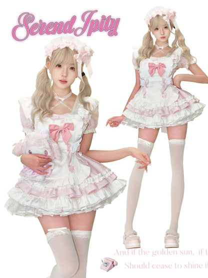 Two people wearing matching white and pink outfits with bows, standing side by side.